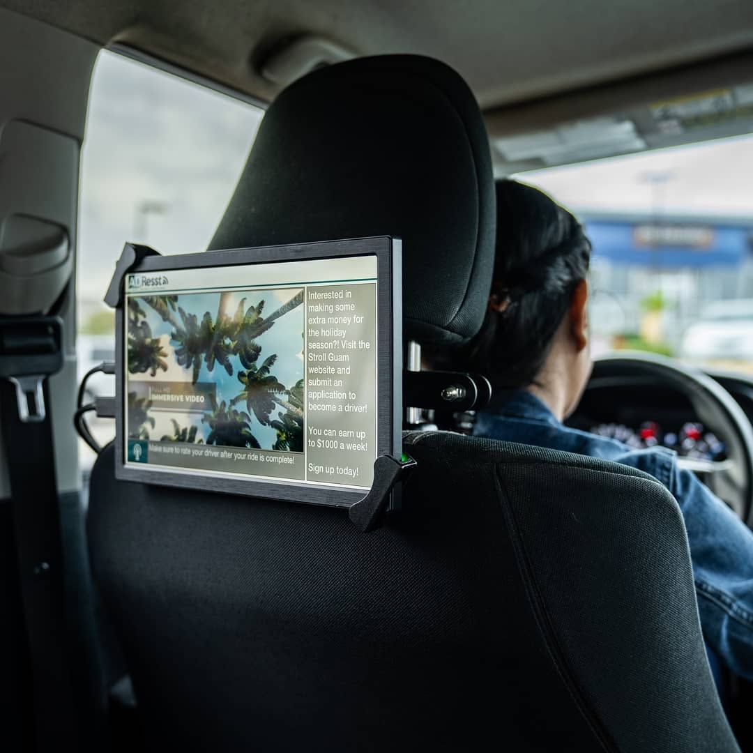 Ultra-HD AdResst headrest tablet running a driver-recruitment campaign during the 2019–2020 Guam deployment